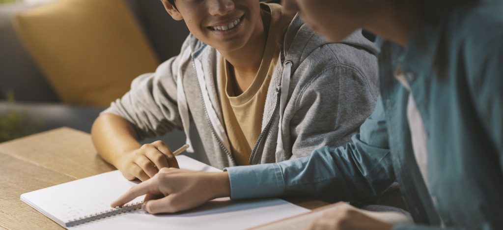 Tutor helping a student with his homework